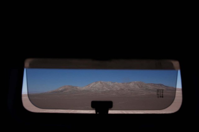 A barren landscape is seen from the bathroom window of a bus on the road near Antofagasta, Chile, November 14, 2017. REUTERS/Carlos Garcia Rawlins SEARCH "RAWLINS BUS" FOR THIS STORY. SEARCH "WIDER IMAGE" FOR ALL STORIES. TPX IMAGES OF THE DAY.