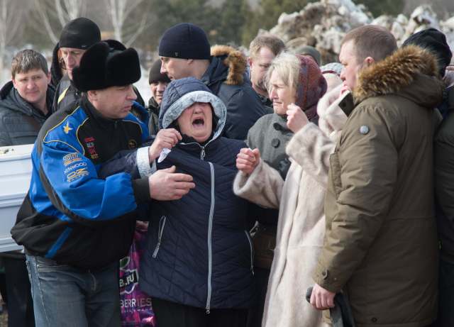 People react during a funeral of a victim of a shopping mall fire at a cemetery in Kemerovo, Russia March 28, 2018. REUTERS/Maxim Lisov