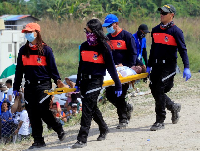 Mary Jane Sazon, 39, is carried on a stretcher after she was nailed on a wooden cross for the 7th time, during a Good Friday crucifixion re-enactment in Cutud village, Pampanga province, north of Manila, Philippines March 30, 2018. REUTERS/Romeo Ranoco