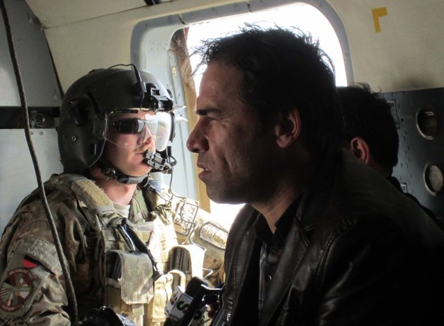 This photo taken in 2013 shows Agence France-Presse (AFP) photographer Shah Marai sitting in a helicopter with a member of the International Security Assistance Force (ISAF) while on assignment in Afghanistan. Agence France-Presse's chief photographer in Kabul, Shah Marai, was killed April 30, AFP has confirmed, in a secondary explosion targeting a group of journalists who had rushed to the scene of a suicide blast in the Afghan capital. Marai joined AFP as a driver in 1996, the year the Taliban seized power, and began taking pictures on the side, covering stories including the US invasion in 2001. / AFP PHOTO / Ben Sheppard