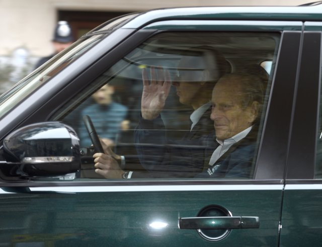 Britain's Prince Philip waves as he is driven away from King Edward VII's Hospital where he recently underwent hip replacement surgery, in central London, April 13, 2018. REUTERS/Peter Summers