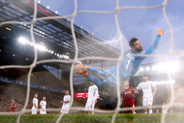 Soccer Football - Champions League Semi Final First Leg - Liverpool vs AS Roma - Anfield, Liverpool, Britain - April 24, 2018   Liverpool's Mohamed Salah scores their first goal as Roma's Alisson Becker looks on        Action Images via Reuters/Carl Recine