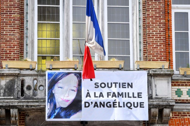 A picture taken on May 1, 2018 in Wambrechies, northern France shows a banner reading 'support to the family of Angelique' and bearing a picture of Angelique in tribute to the 13-year-old girl who was killed and raped on April 25, 2018. The body of Angelique, who had disappeared since April 25, was found in the night from April 28 to April 29 in the countryside in Quesnoy-sur-Deule, northern France. David Ramault, 45 years old, who confessed the crime, was arrested in the night from April 30 to May 1 for kidnapping, rape and murder on minor under 15 years. / AFP PHOTO / PHILIPPE HUGUEN
