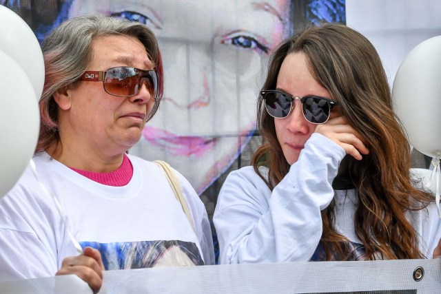 Angelique's mother (L) and sister Anais (R), take part in a march in Wambrechies, northern France, on May 1, 2018, in tribute to Angelique, a 13-year-old girl who was killed and raped on April 25. The body of Angelique, who had disappeared since April 25, was found in the night from April 28 to April 29 in the countryside in Quesnoy-sur-Deule, northern France. David Ramault, 45 years old, who confessed the crime, was arrested in the night from April 30 to May 1 for kidnapping, rape and murder on minor under 15 years / AFP PHOTO