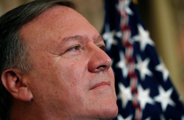 U.S. Secretary of State Mike Pompeo listens to remarks made by President Donald Trump during Pompeo's swearing-in ceremony at the Department of State in Washington, U.S., May 2, 2018. REUTERS/Leah Millis