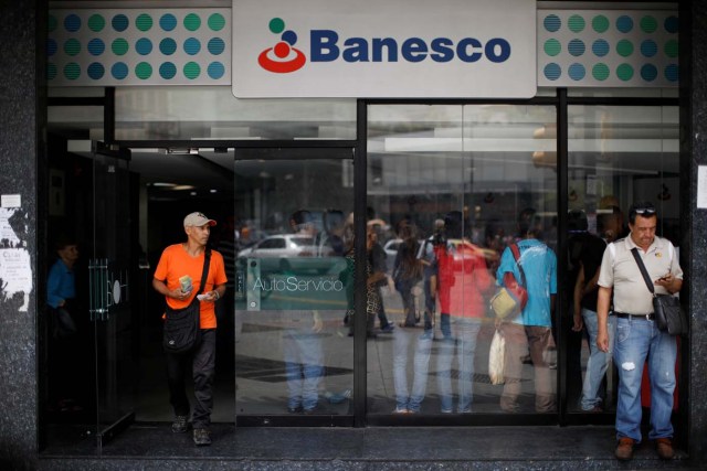 A man walks out from a Banesco bank branch in Caracas, Venezuela May 4, 2018. REUTERS/Carlos Garcia Rawlins