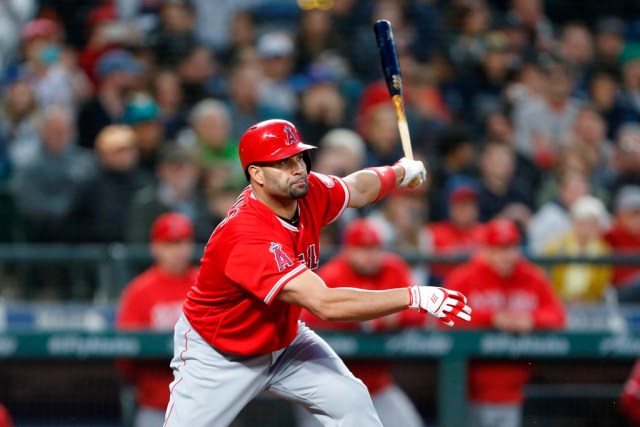 May 4, 2018; Seattle, WA, USA; Los Angeles Angels first baseman Albert Pujols (5) follows through on his 3000 career hit against the Seattle Mariners during the fifth inning at Safeco Field. Mandatory Credit: Jennifer Buchanan-USA TODAY Sports