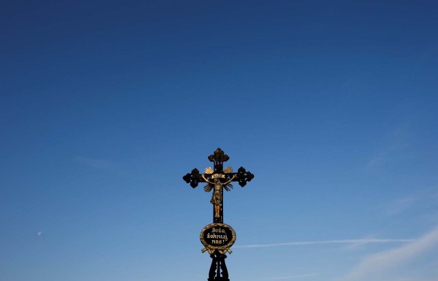 FILE PHOTO: A cross is pictured early morning before German Slavic minority Sorbs leave for a ceremonial horse parade in Ralbitz, Germany, northeast of Dresden, April 20, 2014. More than 1,000 horse riders took part in several parades to mark the resurrection of Jesus Christ on Easter Sunday. REUTERS/Fabrizio Bensch/File Photo