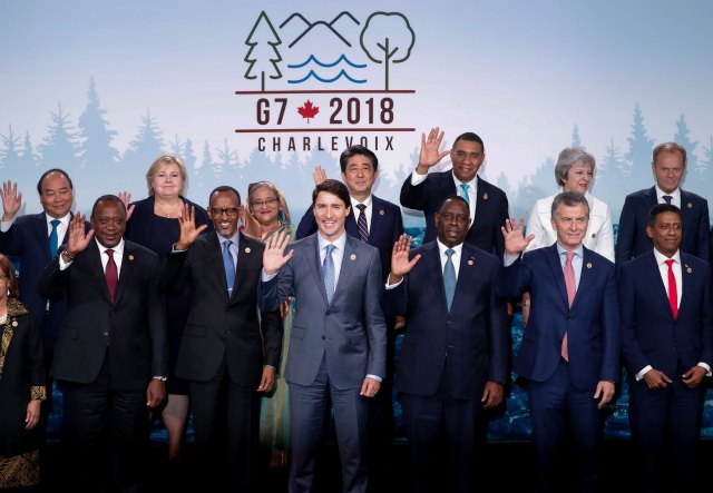 Attendees, including the host, Canada’s Prime Minister Justin Trudeau (C), pose for a G7 and outreach countries summit as part of a G7 summit in the Charlevoix city of La Malbaie, Quebec, Canada, June 9, 2018. REUTERS/Yves Herman